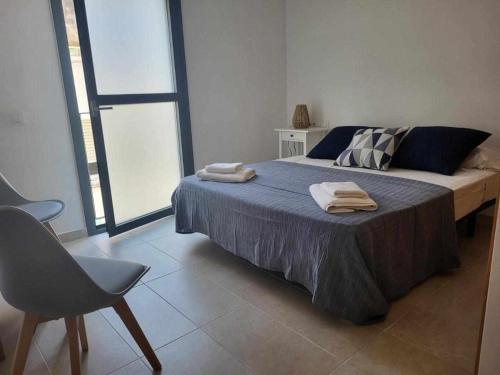 a bedroom with a bed with two towels on it at Roses Casc Antic S L Sabater 1 in Roses