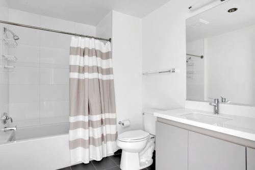 a white bathroom with a sink and a toilet at Downtown 1BR w Pool Jacuzzi Gym nr 110 LAX-836 in Los Angeles