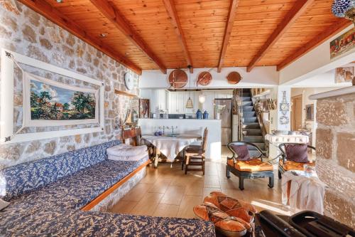 a living room with a couch and a table at Magical view, Villa Asproneri, Kamena Vourla in Kamena Vourla
