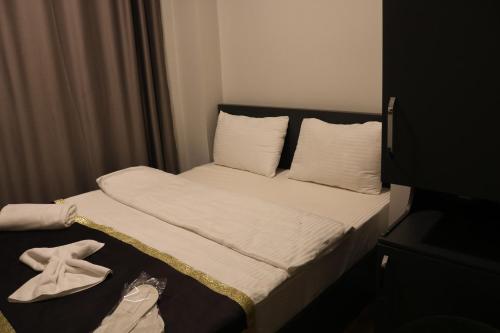 a small room with a bed with a towel on it at Ortek Hotel Taksim in Istanbul