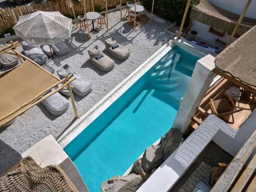 an overhead view of a pool with chairs and a table at Sandaya Luxury Suites in Naousa