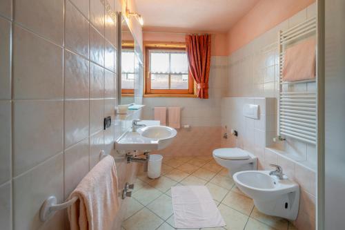 een badkamer met 2 wastafels en 2 toiletten bij Appartamenti Stefano in Livigno