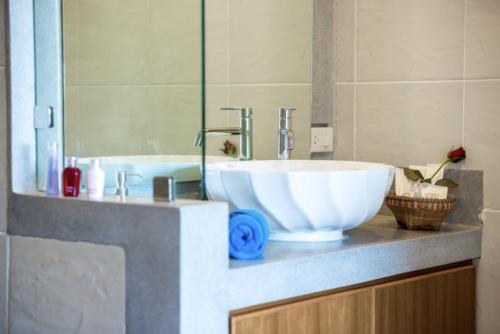 a bathroom with a large white bowl sink on a counter at Scenery Sunrise in Chaweng Noi Beach