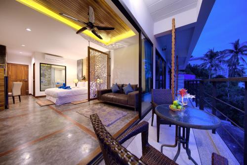 a living room with a bed and a table at Scenery Sunrise in Chaweng Noi Beach