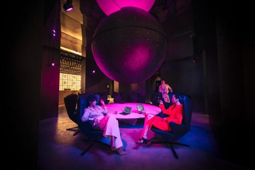 a group of people sitting around a table in a room at Zonar Zagreb by Maistra City Vibes in Zagreb