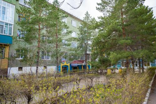 a playground in a park next to a building at Светлая двухкомнатная квартира с Wi-Fi стильный дизайн и всё необходимое in Aktobe