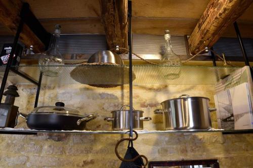 a kitchen with pots and pans on a shelf at Dimora 421 Apartsuite in Chioggia