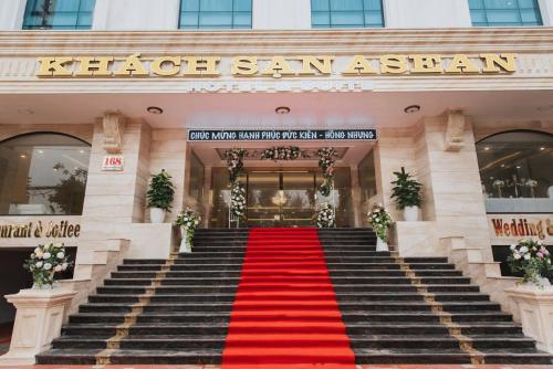 a staircase leading to a hotel with a red carpet at Asean Hotel in Hải Dương