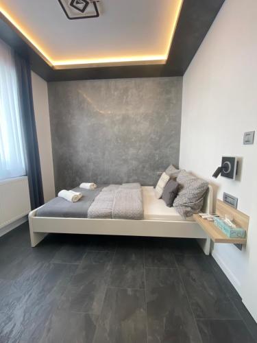 a bedroom with a large bed in a room at Airport Almáskert Panzió in Vecsés