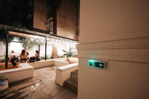 a bathroom with a green sign on the wall at When in Athens Hostel in Athens