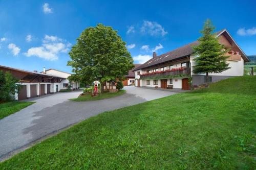 an empty road leading to a building with a tree at Winzerhof Wörner in Durbach