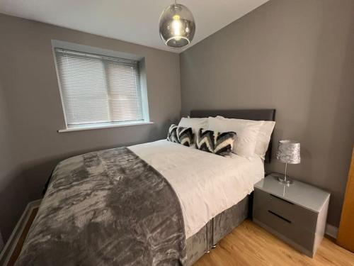 a bedroom with a large bed and a window at Apartment in Birkdale - 2 bedrooms in Southport