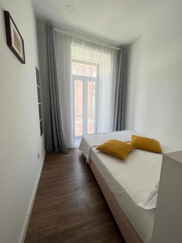 a bedroom with a bed and a large window at Pérola do Ar - Estúdio no coração de Setúbal in Setúbal