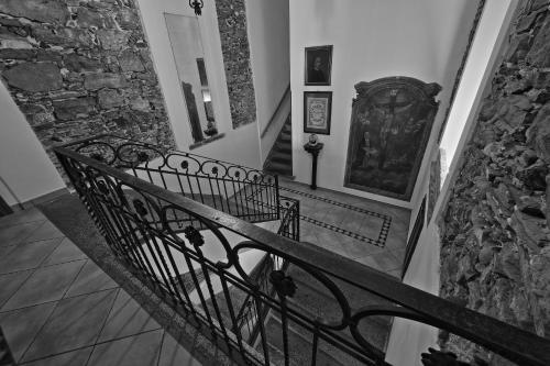 a stairway with a railing and a stone wall at Locanda La Pergola in Bellagio