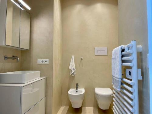 a bathroom with a white toilet and a sink at Ad appena 50 metri dal mare! in Trapani