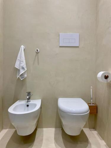 a bathroom with a white toilet and a sink at Ad appena 50 metri dal mare! in Trapani