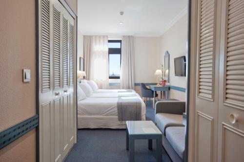 Ένα ή περισσότερα κρεβάτια σε δωμάτιο στο Espahotel Gran Vía