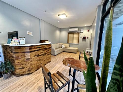 a lobby with a bar and a table and chairs at Harbour Bliss Hotel in Coron