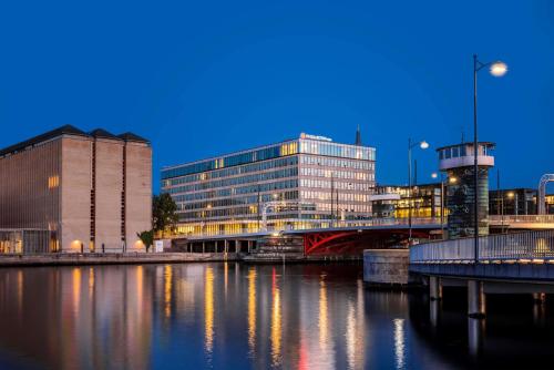 a city with buildings and a river at night at NH Collection Copenhagen in Copenhagen