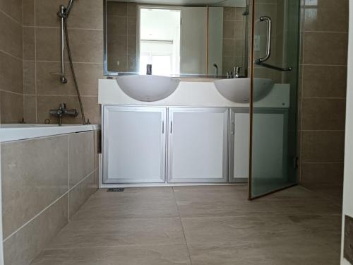 a bathroom with two sinks and a mirror at Menara Bintang Goldhill in Kuala Lumpur