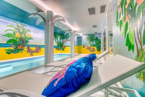 a room with a swimming pool and a large inflatable room at The Pink Elephant Hotel in S'Agaro