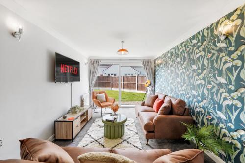 a living room with two couches and a tv at Contractor Heaven! Huge Driveway For 4 Vans, Comfy Beds, Netflix & Garden in Chelmsford