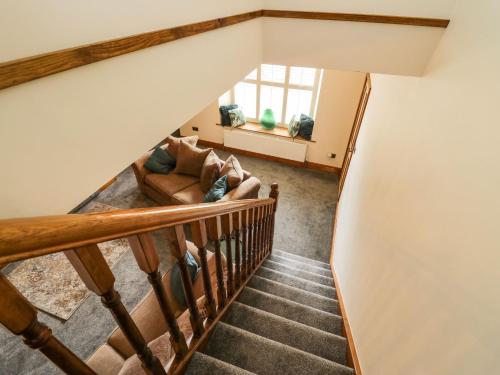 a staircase in a house with a living room at The Anvil in Broughton in Furness