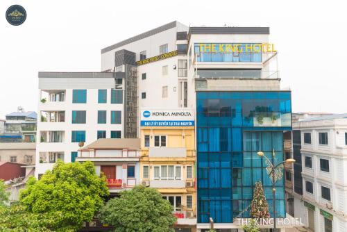 a tall building with a sign for the ticking city at The King Hotel - Condotel Thai Nguyen in Thái Nguyên