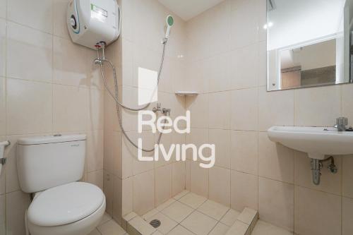 a bathroom with a white toilet and a sink at Redliving Apartemen Springlake Summarecon - MDH Rooms Tower Caldesia with Netflix in Bekasi