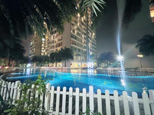 a white fence in front of a large building at KABILUX HOUSE - 1-2-3 Bedrooms in Vinhomes Times City in Hanoi