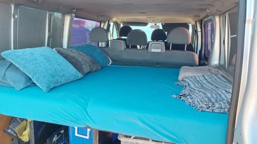 a bed in the back of a van with pillows at Casa movil in Santa Gertrudis de Fruitera