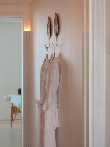 a rack of white towels hanging on a wall at The Standard, Ibiza in Ibiza Town
