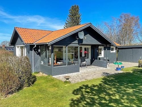 a small house with a patio in a yard at 6 person holiday home in Glesborg in Glesborg