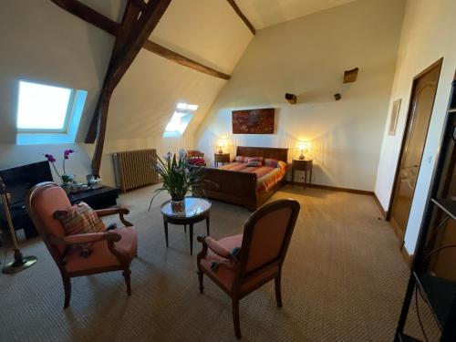 a large living room with a bed and chairs at Domaine de la Carrère in Arthez-de-Béarn