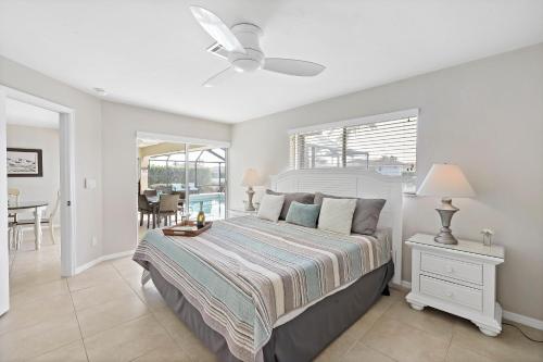 a bedroom with a bed and a dining room at 152 Leeward Court in Marco Island