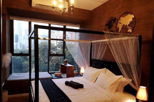 a bedroom with a canopy bed with a large window at Romantic Log Cabin 2 - Heart of KL, near KLCC/KL Tower in Kuala Lumpur