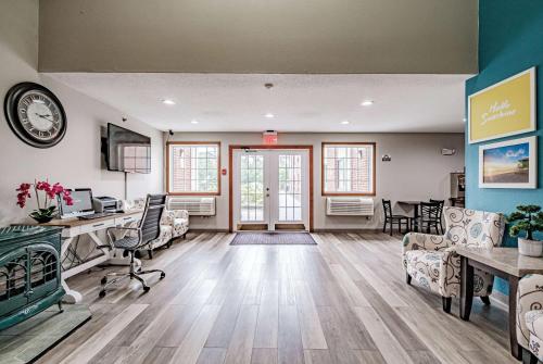 an office with desks and chairs and a clock on the wall at Days Inn by Wyndham Brunswick Bath Area in Brunswick