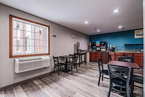 a restaurant with tables and chairs and a window at Days Inn by Wyndham Brunswick Bath Area in Brunswick