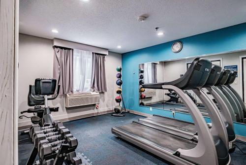 a gym with a treadmill and a mirror at Days Inn by Wyndham Brunswick Bath Area in Brunswick