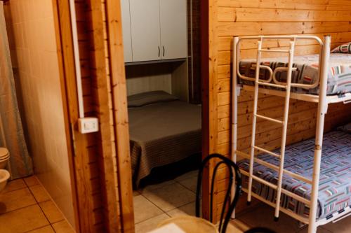 a small room with a bunk bed in a cabin at Camping La Pineta in Porto Recanati