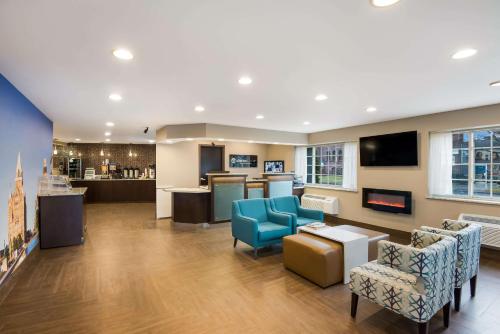 a waiting room with blue chairs and a counter at Clarion Pointe Downtown in Syracuse