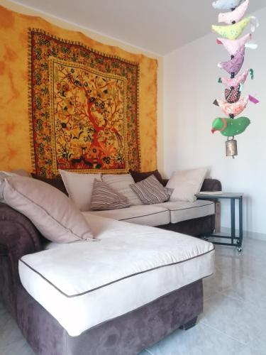 a room with two beds and a tapestry on the wall at Demetra Piccola Casa Vacanze in Ielsi