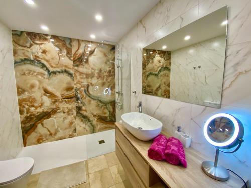 a bathroom with a sink and a mirror at BLUE DIAMOND luxury apartment with amazing seaview in Costa Adeje in Adeje