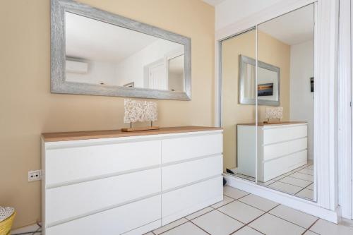 a dressing room with white dressers and a mirror at Sea Front Beach house Micaela G in Marbella