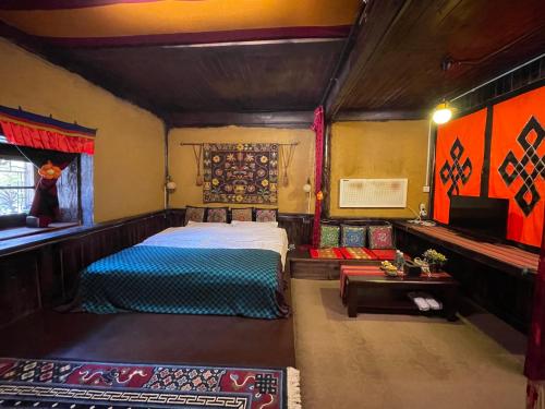 a bedroom with a bed and a table in a room at Timeless Inn in Shangri-La