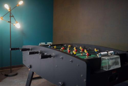 a table with a chess board in a room with a light at Vienna House Easy by Wyndham Bucharest Airport in Otopeni