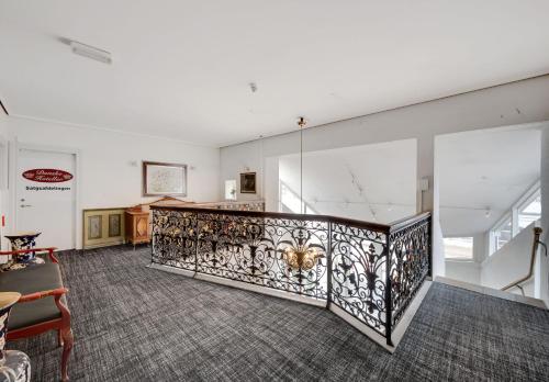 an empty room with a wrought iron railing at Hotel Hjallerup Kro in Hjallerup