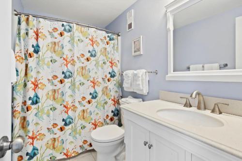 a bathroom with a shower curtain with a toilet and a sink at Myrtle Beach Resort T1402 in Myrtle Beach