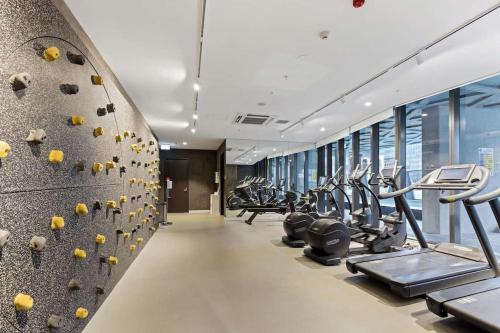 a gym with a row of treadmills and machines at Realm 1206 in Adelaide