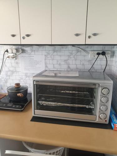 a toaster oven sitting on top of a counter at Telperio - Guest suite max 4 Guests in Bunbury